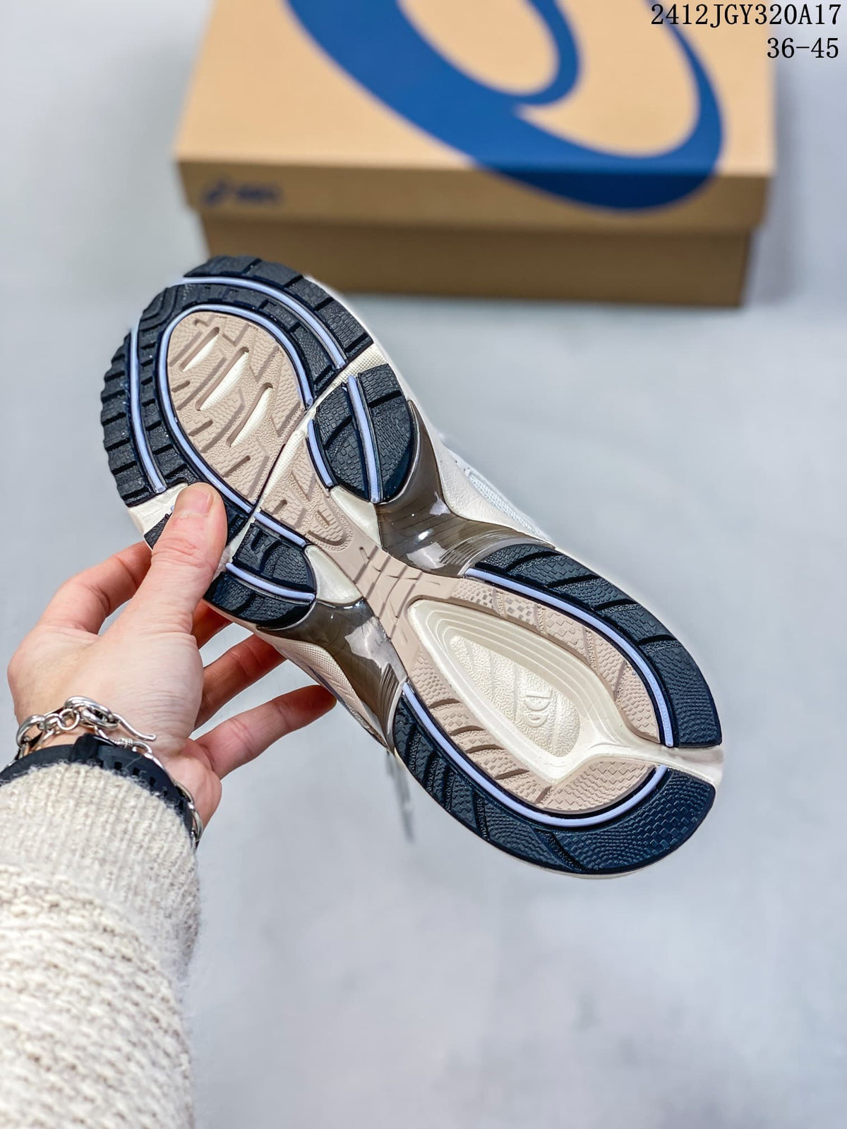 Underside of a white and blue ASICS GEL-1090 sneaker showing its patterned outsole; image shows size range 36–45.
