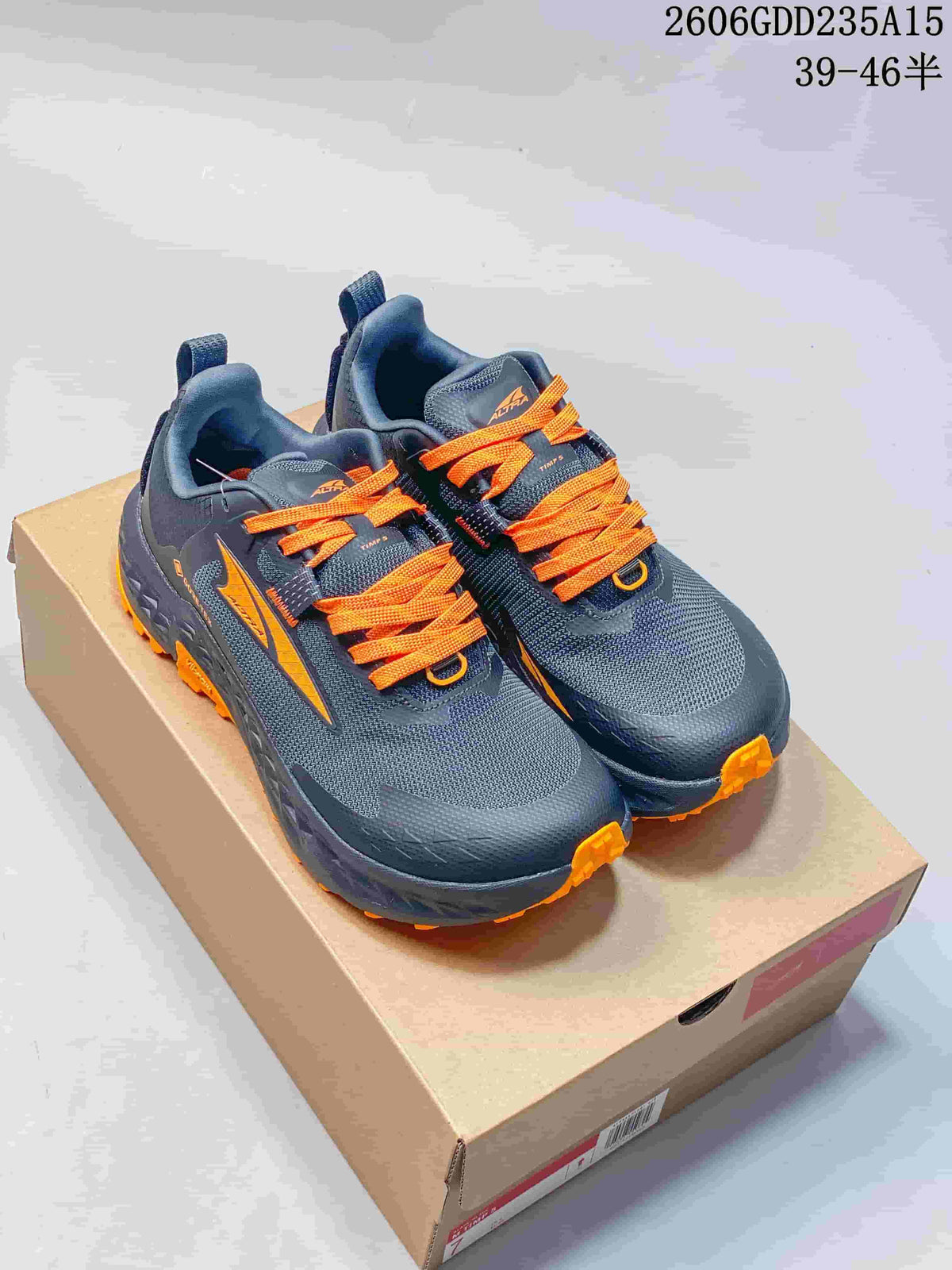 Gray and orange Altra Timp 5 GTX trail shoes shown from the front on a box.