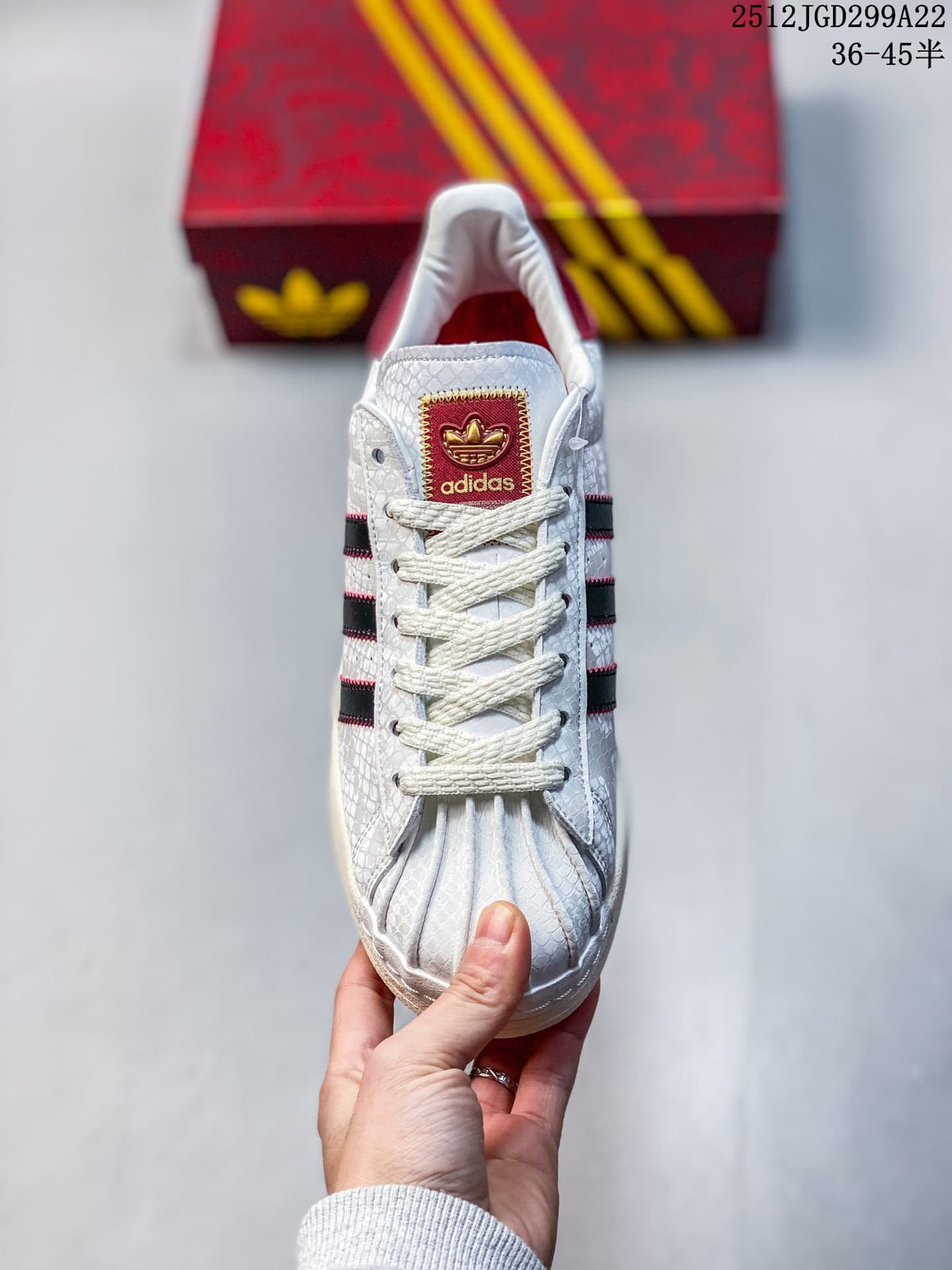 Front view showing the shell toe, white laces, and burgundy tongue label.