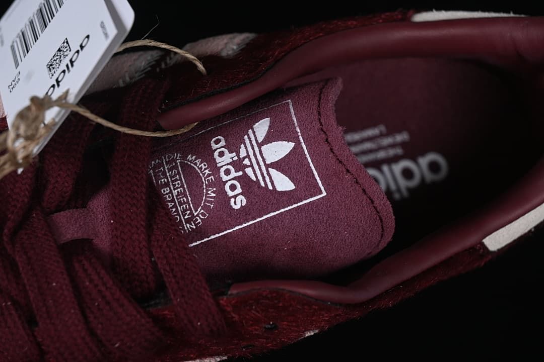 Close-up of Adidas Trefoil branding on the tongue and interior