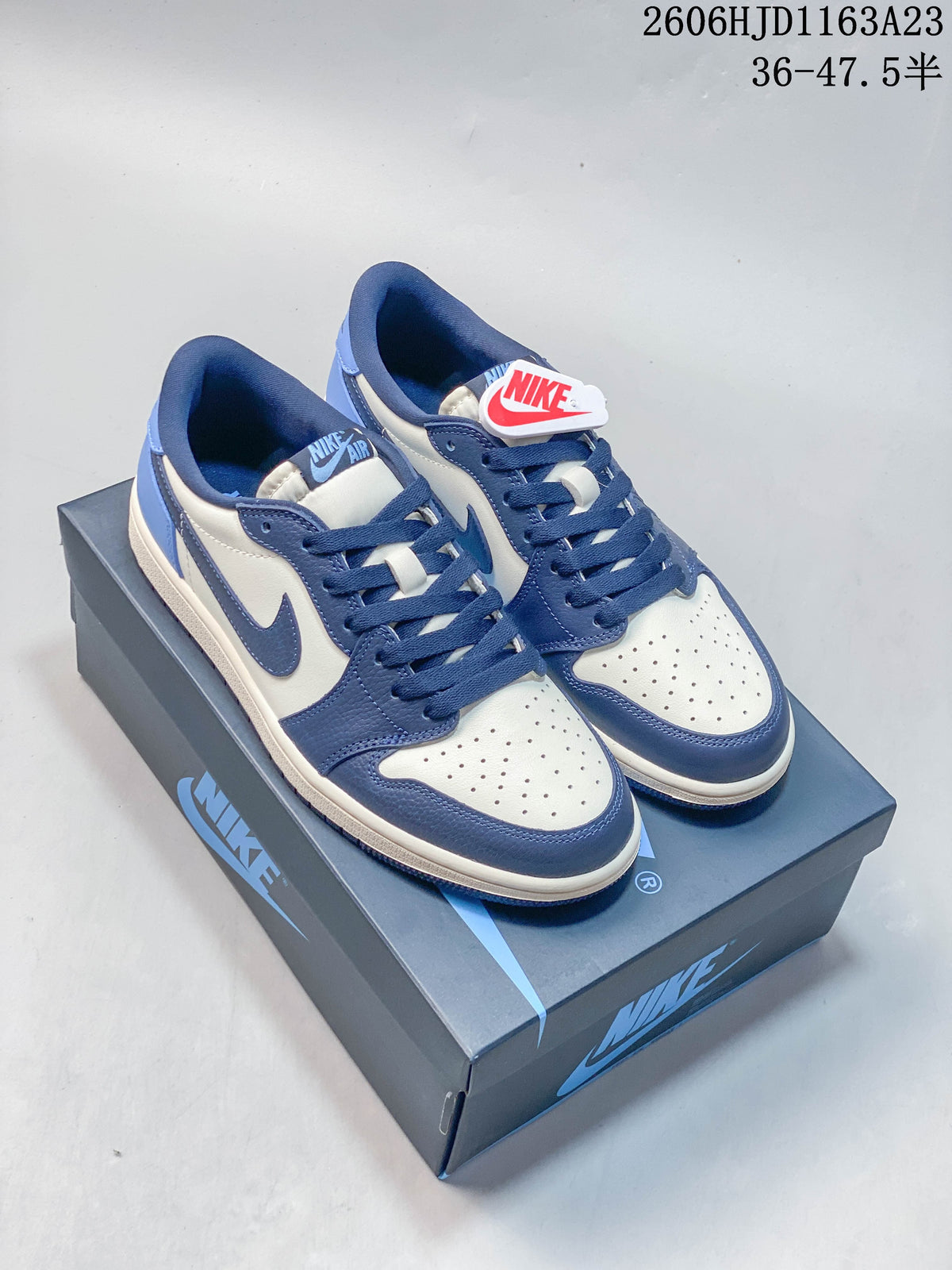 Pair of blue and white low-top Air Jordan 1 sneakers displayed on a shoe box