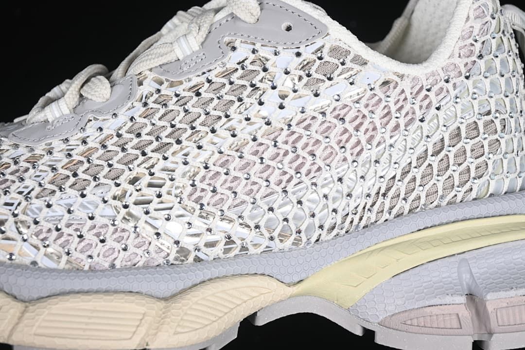 Close-up of the side openwork upper, laces and segmented sole