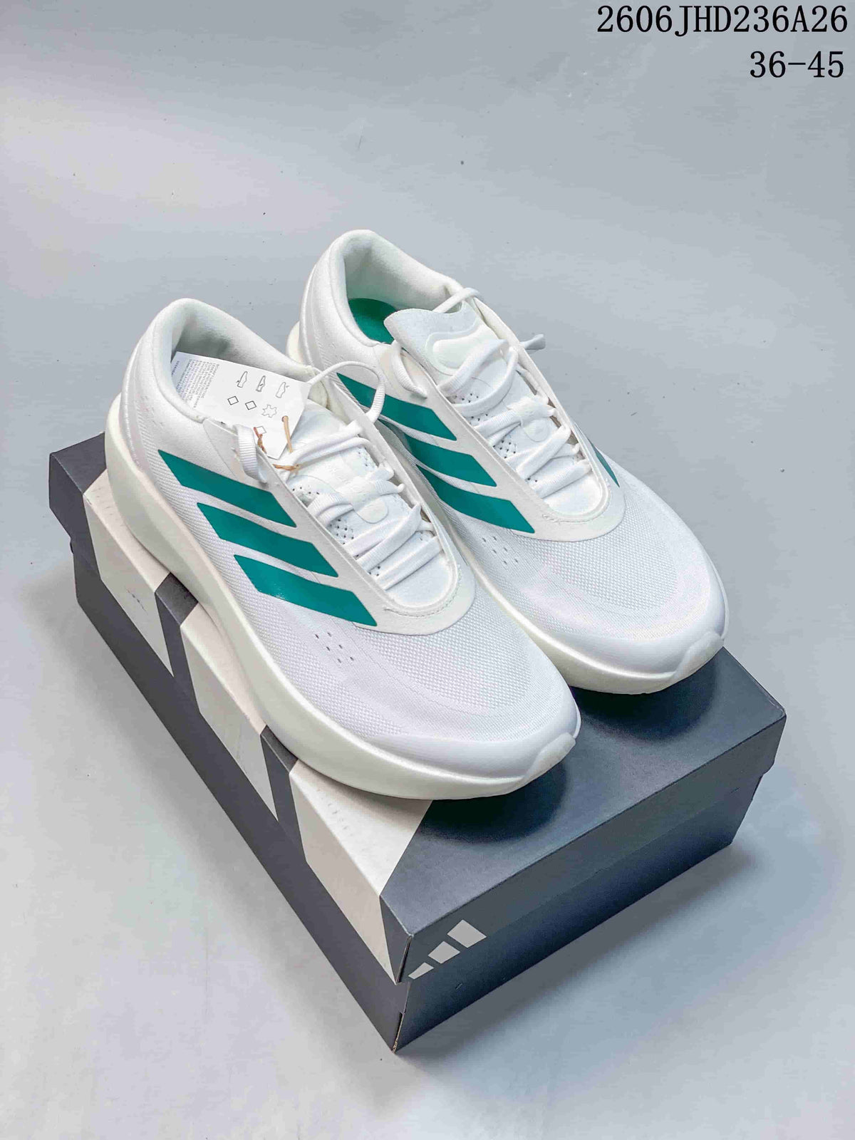 White adidas ZENBOOST low-top shoes with teal side stripes, shown on a shoe box.