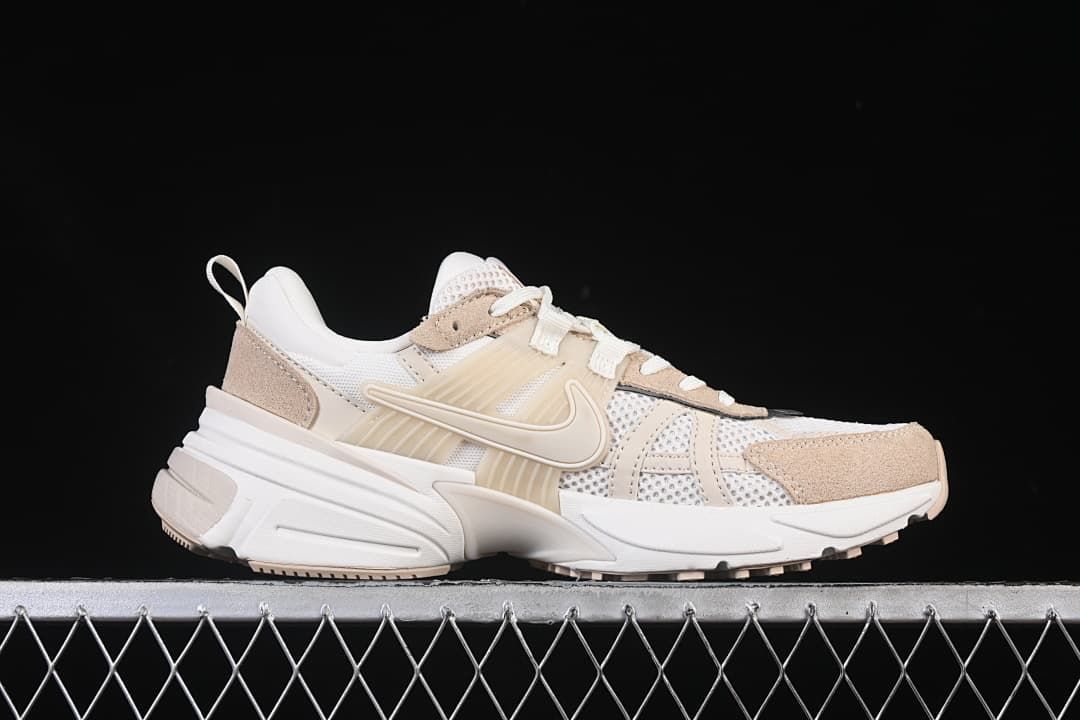 Side profile of one white and beige sneaker