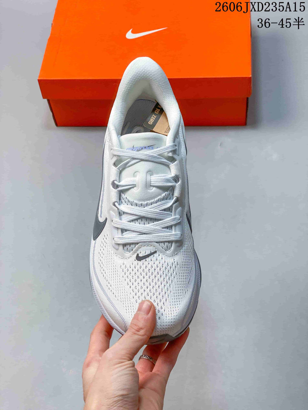 Top view of the white Nike Pegasus 42 running shoe with laces and mesh-patterned upper