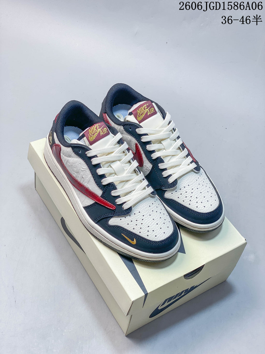 Pair of white, navy, and red Nike Dunk low-top sneakers shown on a shoe box