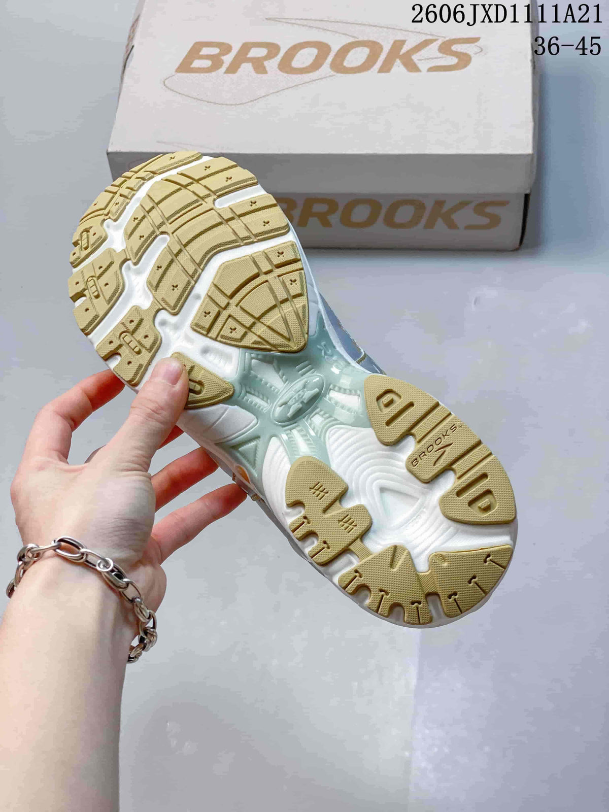 Underside of a Brooks sneaker showing a tan and white patterned outsole