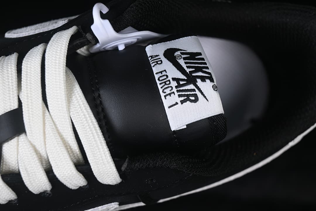 Close-up of the Nike Air Force 1 tongue label and white laces