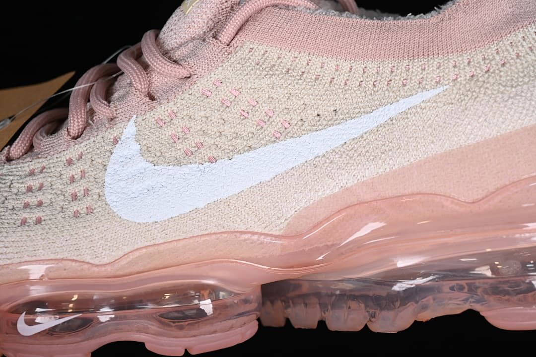 Close-up of the knit-patterned upper, white Swoosh, and visible sole units.