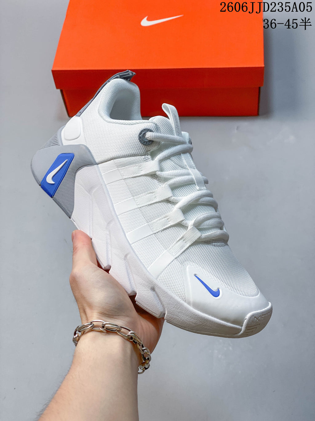 Angled side view of a white Nike Free Metcon 7 shoe with blue accents