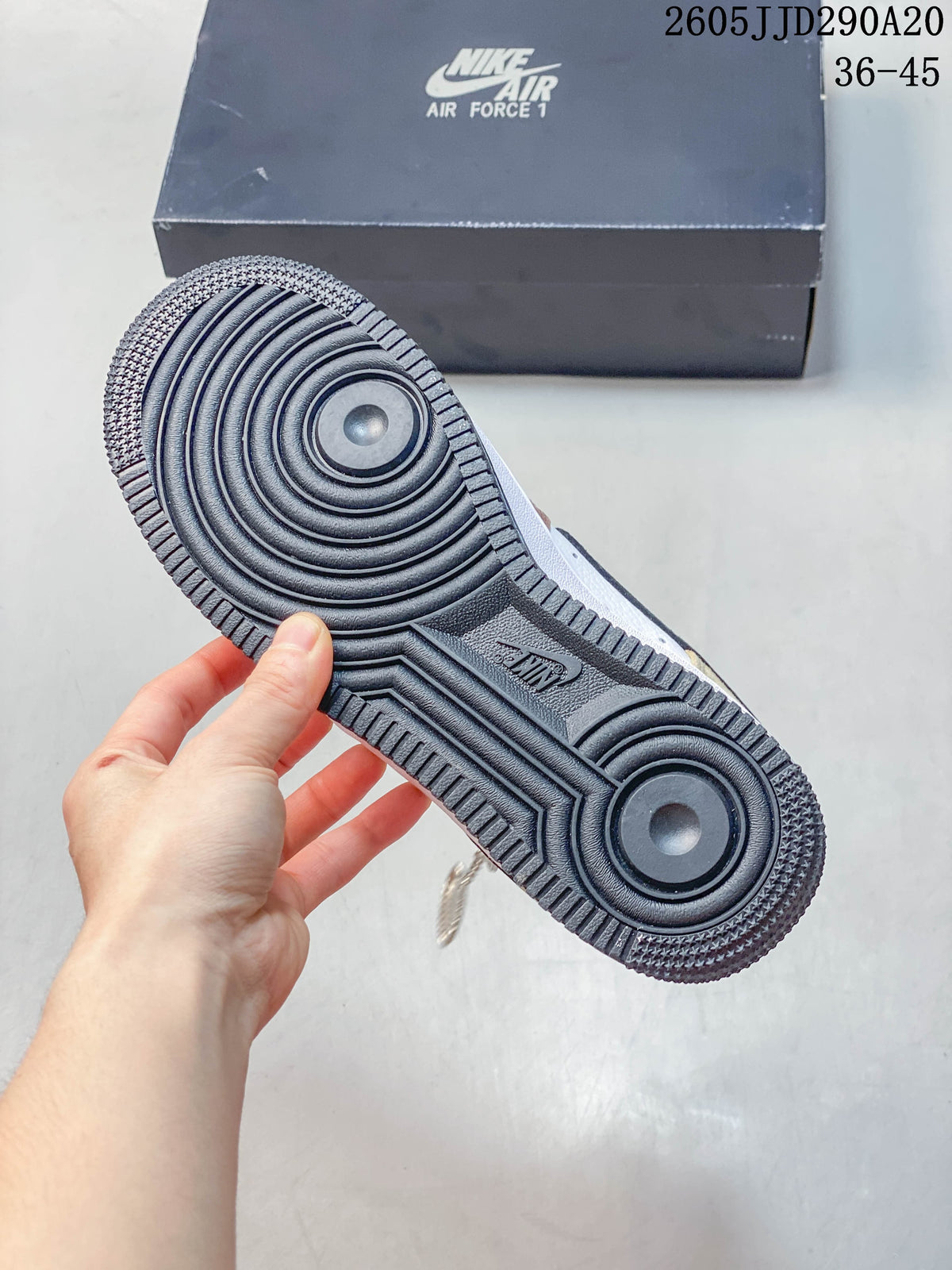 Close-up of the dark outsole and circular tread pattern on a Nike Air Force 1 Shadow sneaker