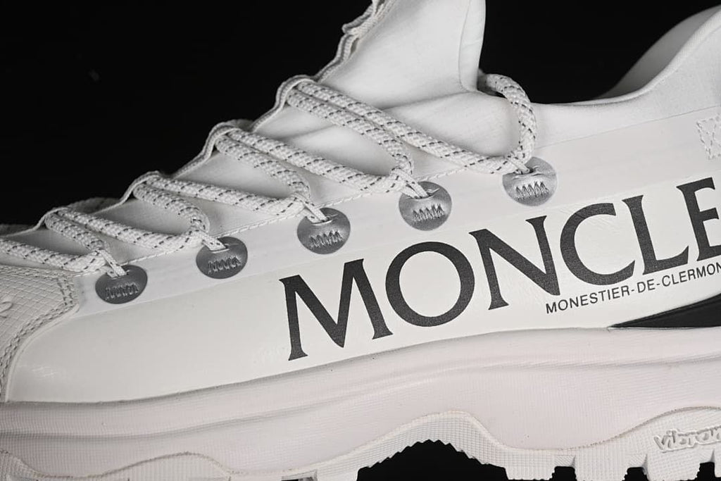Close-up of side branding, lace loops, and outsole edge