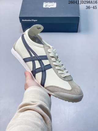 Cream and white Mexico 66 sneaker with dark navy side stripes and gray toe detailing.