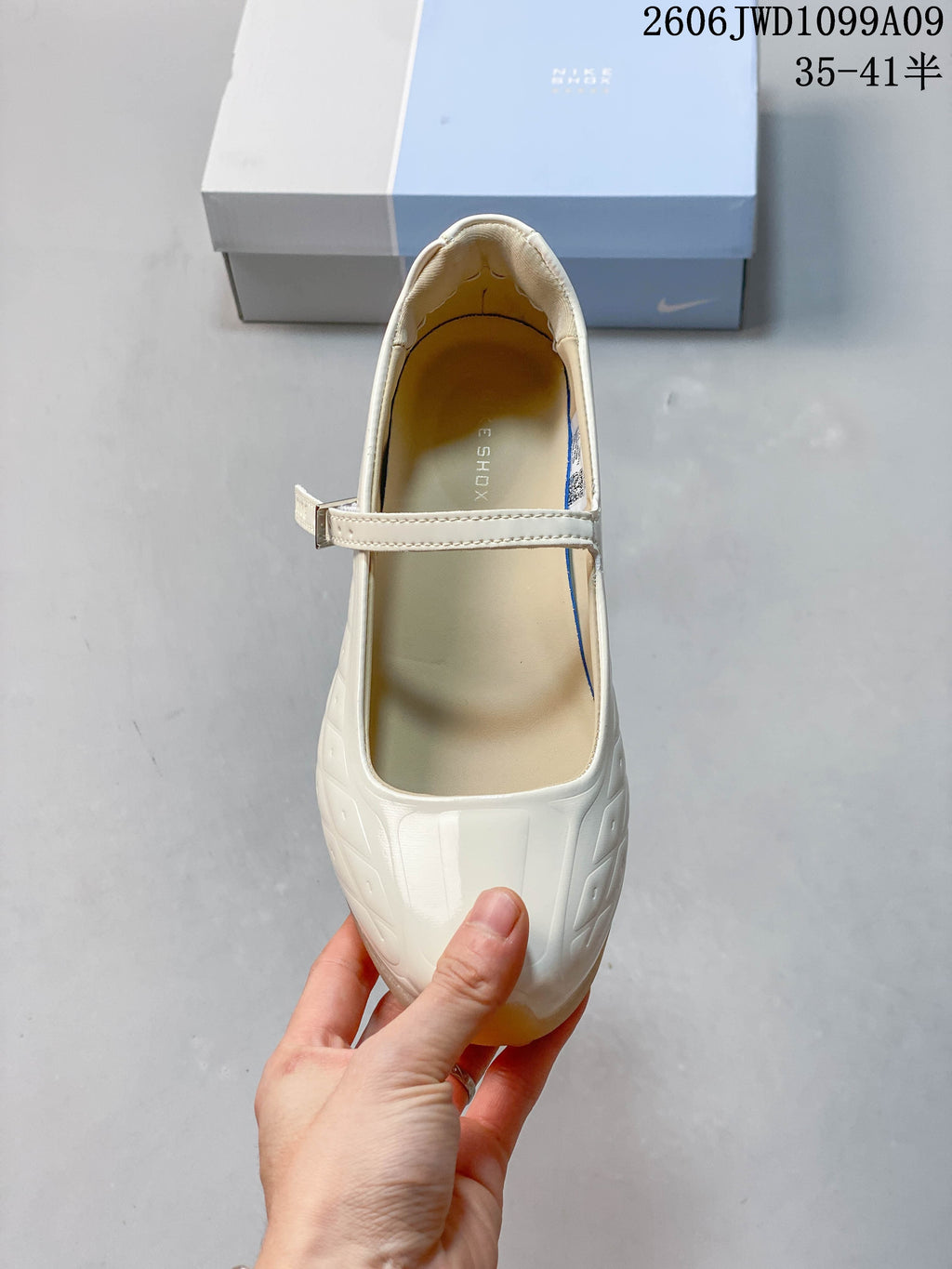 Top view of an ivory Mary Jane sneaker with an adjustable strap