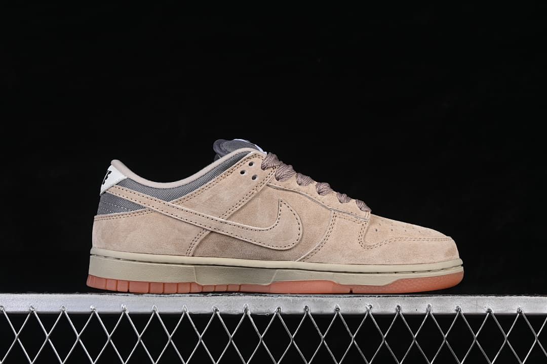 Side profile of the sneaker with beige panels and grey heel accents
