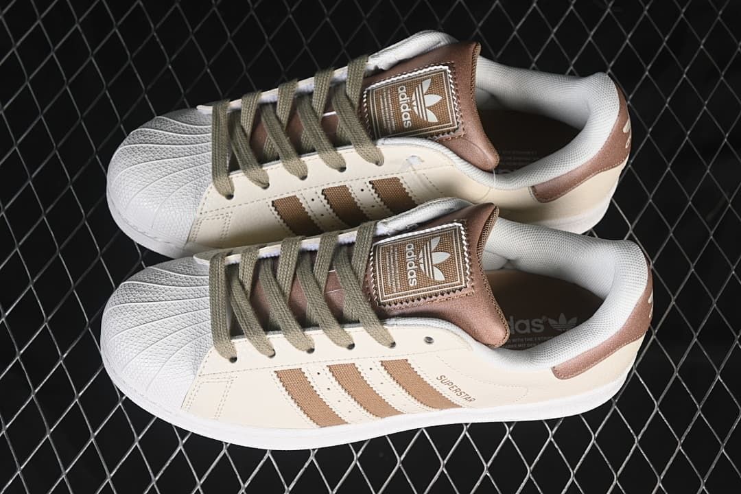 Pair of cream and brown Superstar II sneakers shown from above.