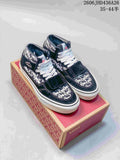 Navy Vans Era 95 Reissue-style sneakers with Fear of God name print, white laces and a forefoot strap, displayed on a Vans box.