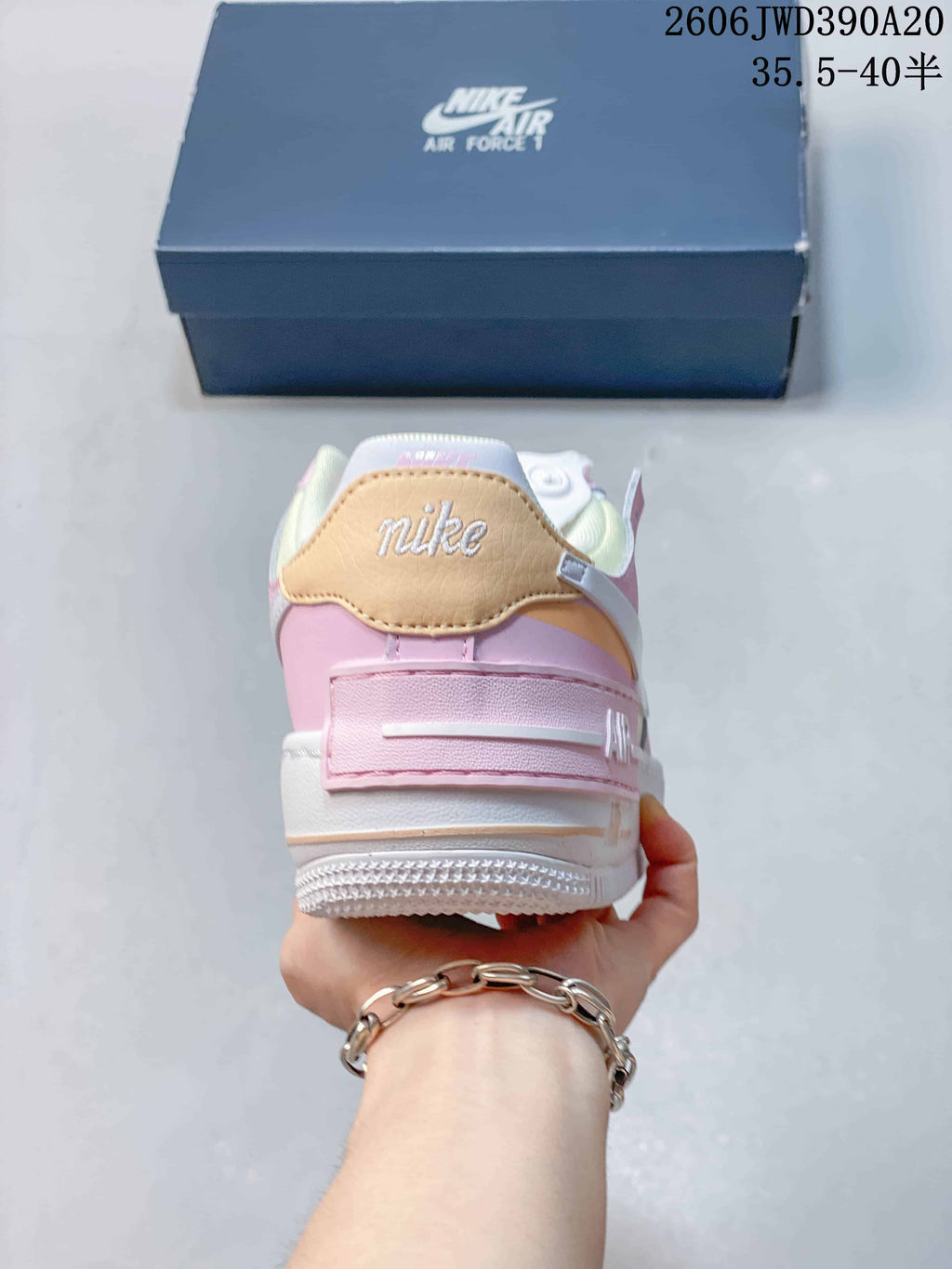 Rear view of the pastel Nike Air Force 1 sneaker with a pink heel strap and contrasting heel panel.
