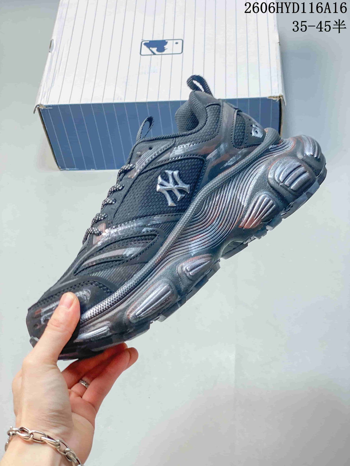 Side view of a charcoal MLB NY sneaker with graphic accents and a sculpted sole