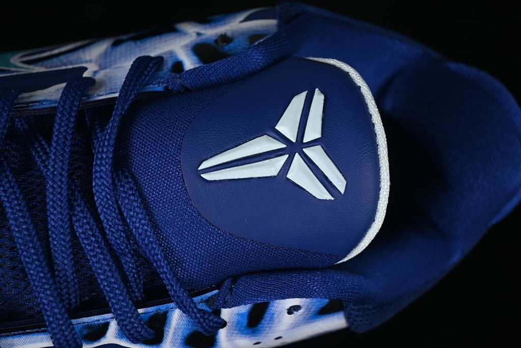 Close-up of the tongue logo and dark blue laces