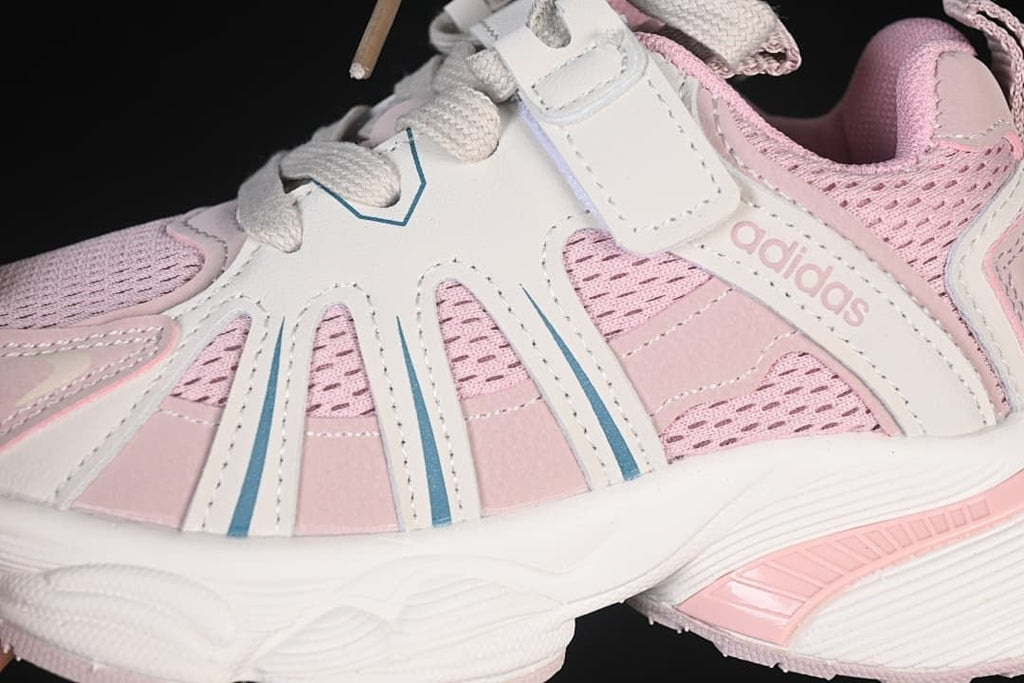 Close-up of the pink mesh-look upper, side overlays, laces, and strap