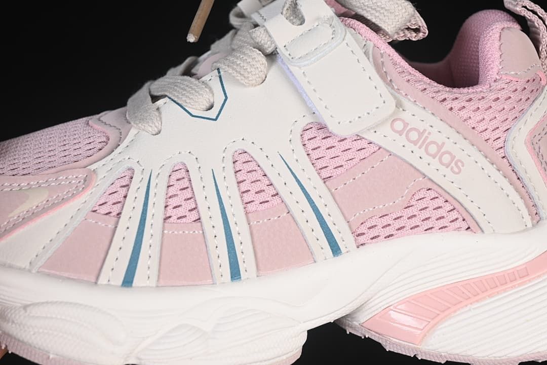 Close-up of the pink mesh-look upper, side overlays, laces, and strap