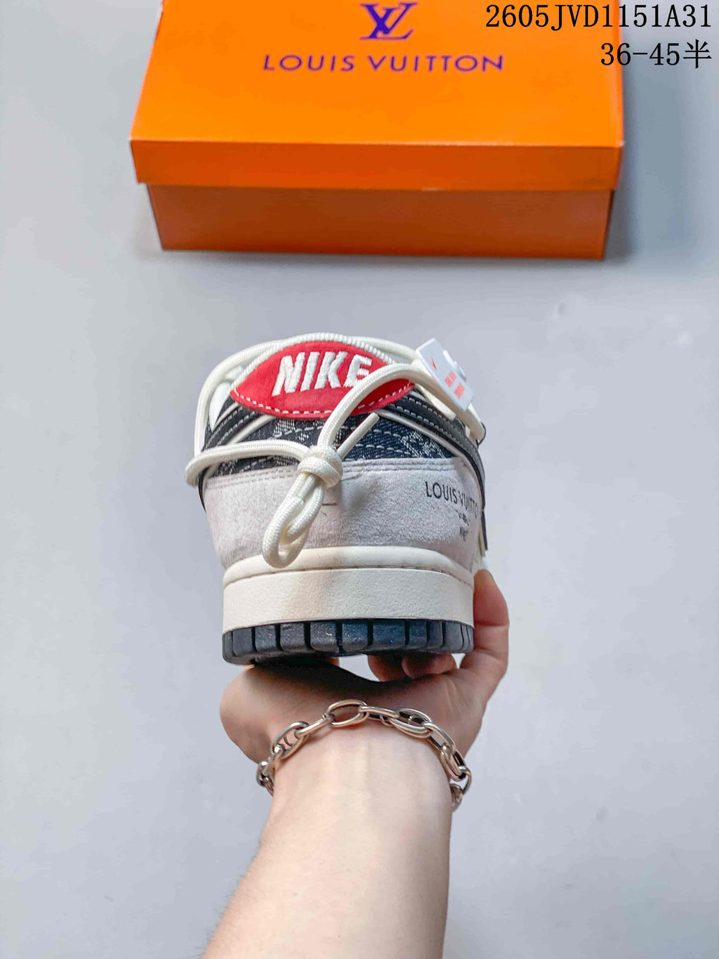 Rear view of the sneaker showing a red heel tab and white midsole.