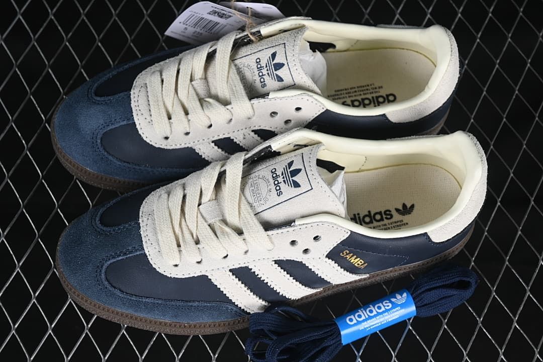 Pair of navy and cream Samba OG sneakers with an extra set of navy laces