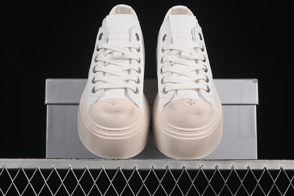 Front view of the pair showing the laces, toe motifs, and thick platform soles.