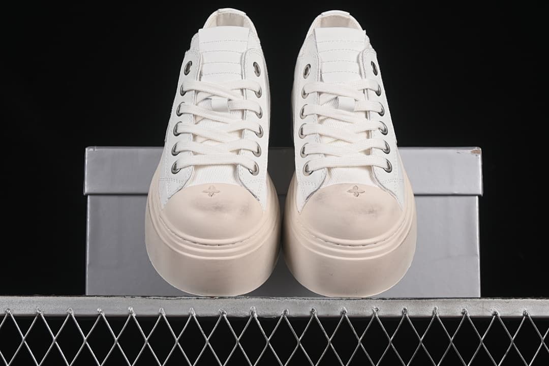 Front view of the pair showing the laces, toe motifs, and thick platform soles.