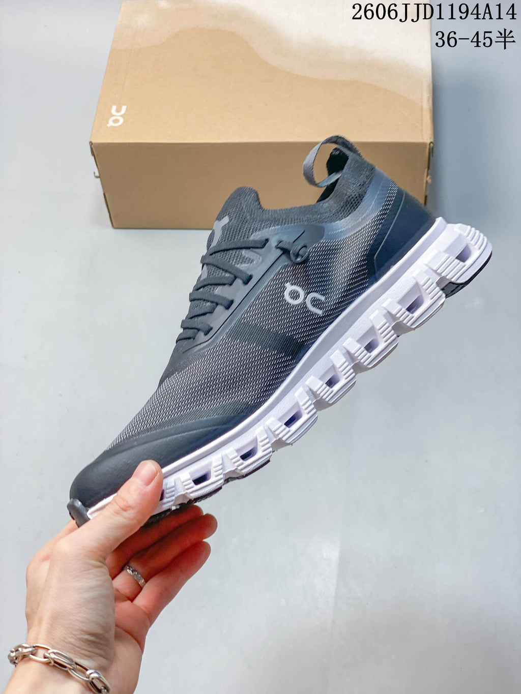 Side view of the charcoal Cloud 6 Versa sneaker and its segmented white sole
