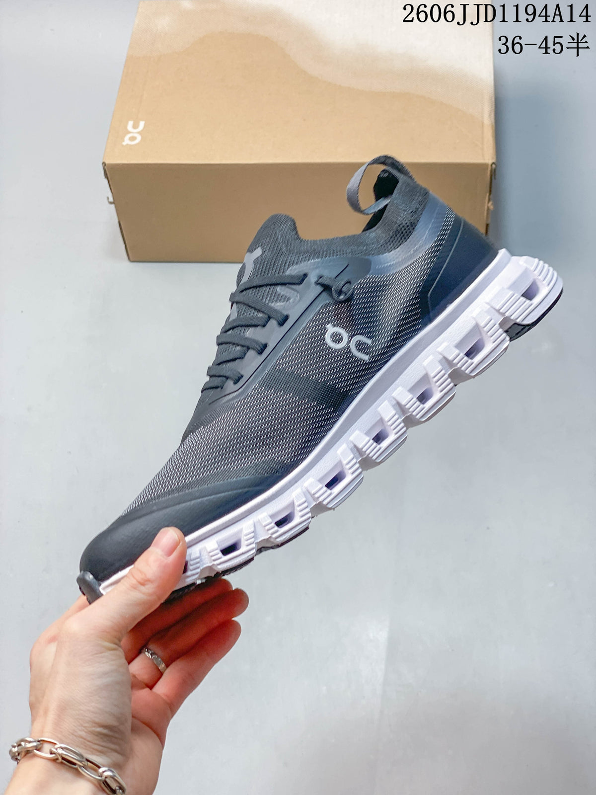 Side view of the charcoal Cloud 6 Versa sneaker and its segmented white sole