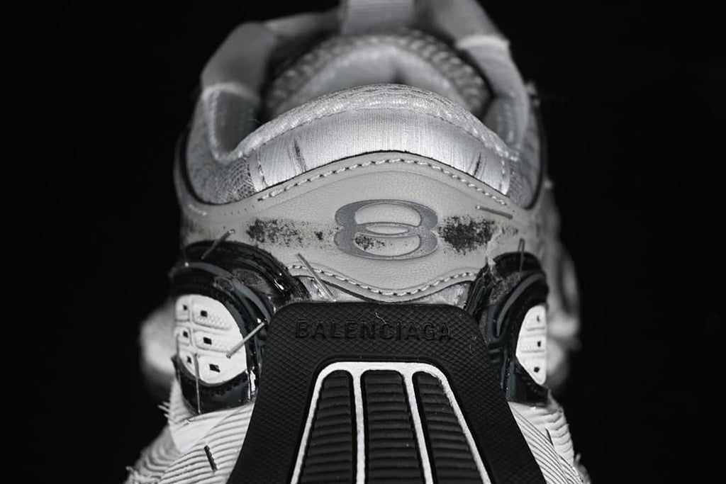 Rear view showing heel branding and layered black and white sole details