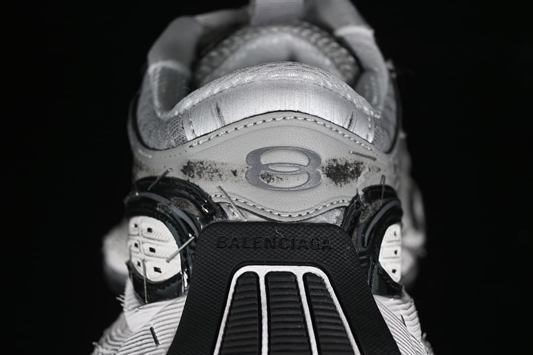 Rear view showing heel branding and layered black and white sole details