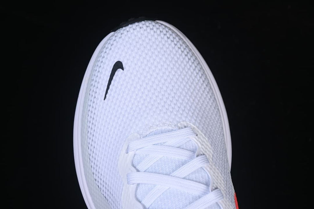 Top view of the textured white toe with a small black Swoosh