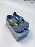 Pair of gray FiveFingers-style shoes with individual toe compartments and adjustable straps, displayed on a box
