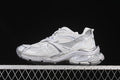 Side view of a grey and silver Balenciaga Runner 2 sneaker against a dark background.