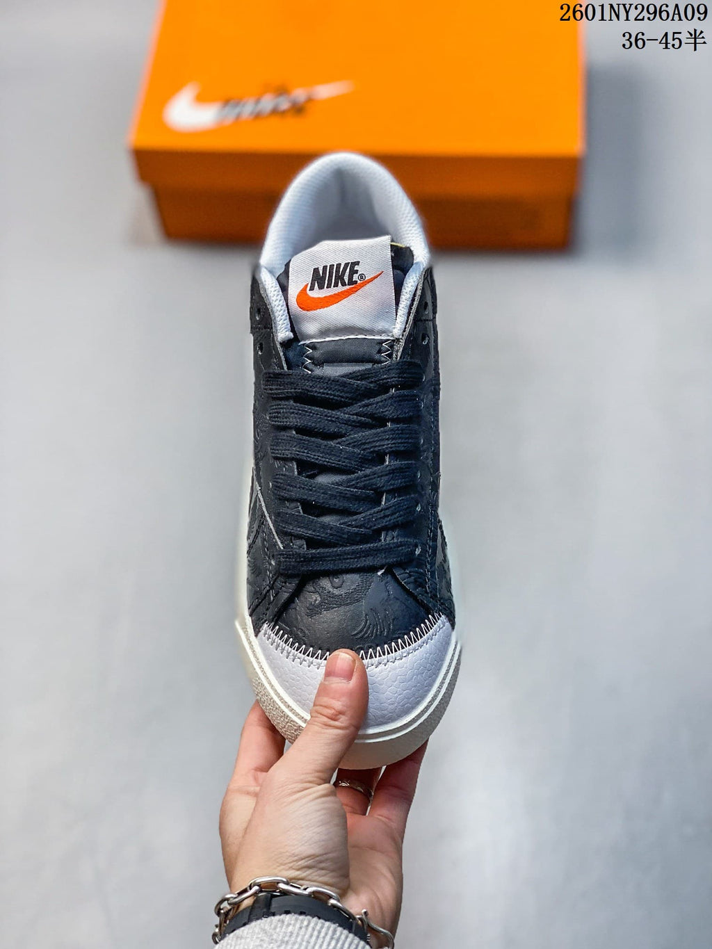 Front view of the sneaker with dark laces, patterned upper, and contrasting light toe.