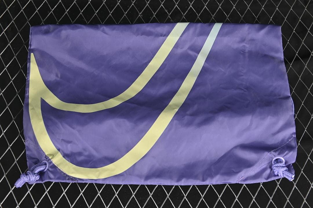 Purple drawstring shoe bag with a large pale graphic