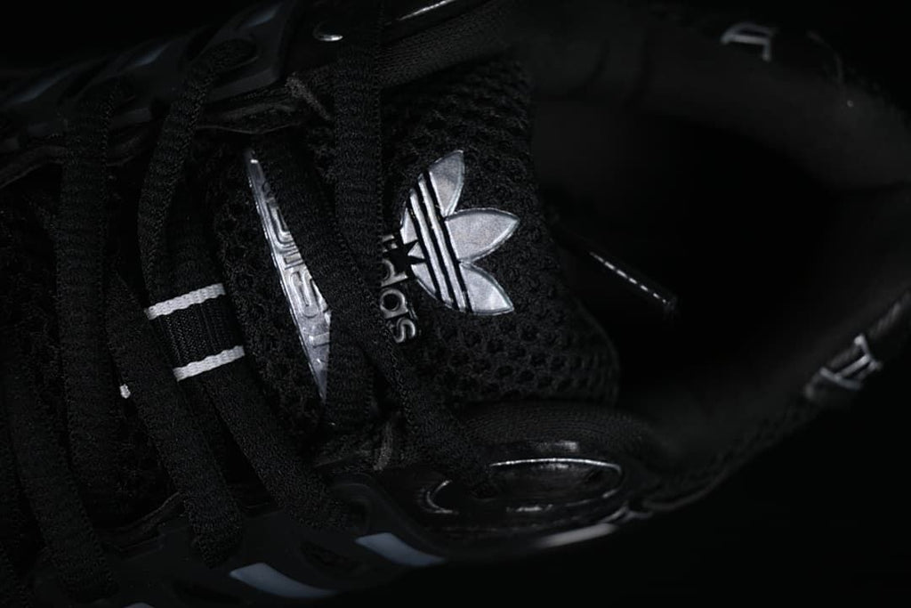 Close-up of the tongue branding and black laces