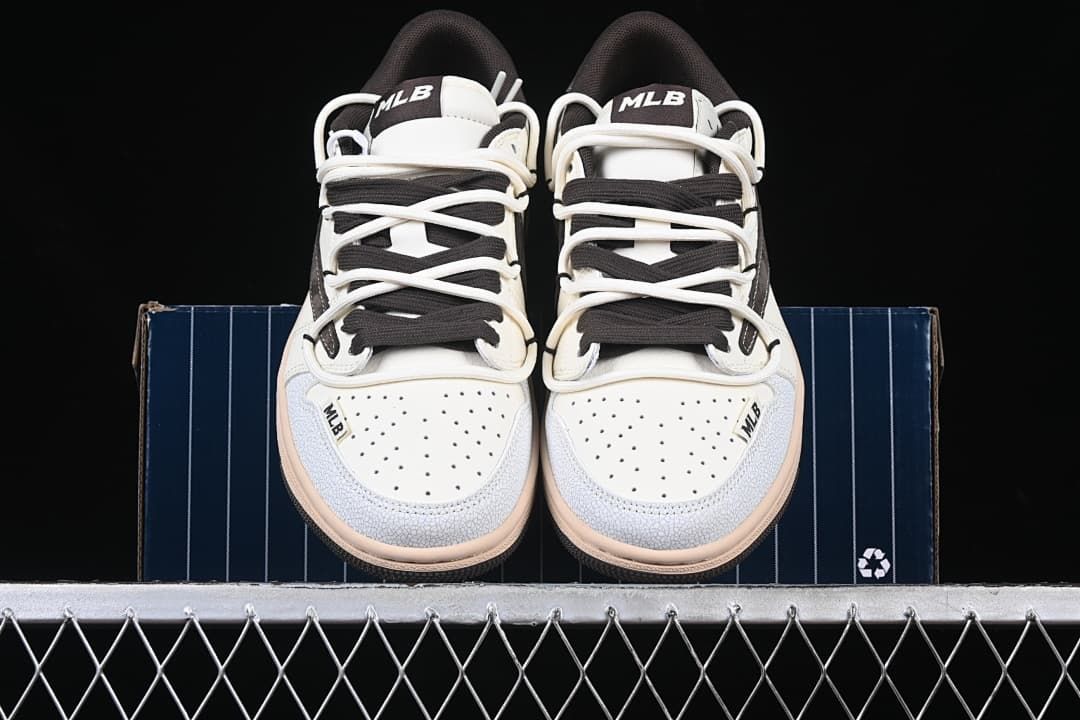 Front view of both sneakers with perforated toe panels and layered laces