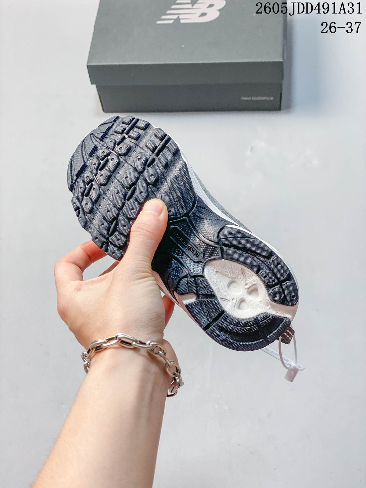 Close-up of the patterned outsole on a gray kids' sneaker