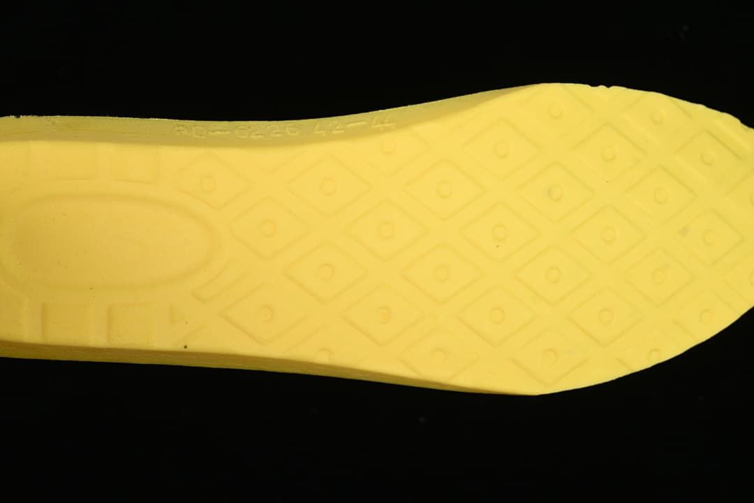 Close-up of the boot's yellow outsole