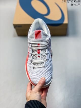 Top view of the white ASICS sneaker showing the lace system, tongue and red branding details.
