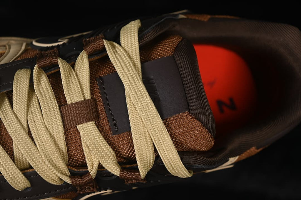 Top detail of the laces, tongue, and brown mesh upper
