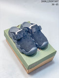 Pair of dark navy KEEN closed-toe clog sandals with adjustable straps, displayed on a shoe box.