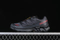 Side view of dark gray and black Salomon XT-6 sneakers with red accents
