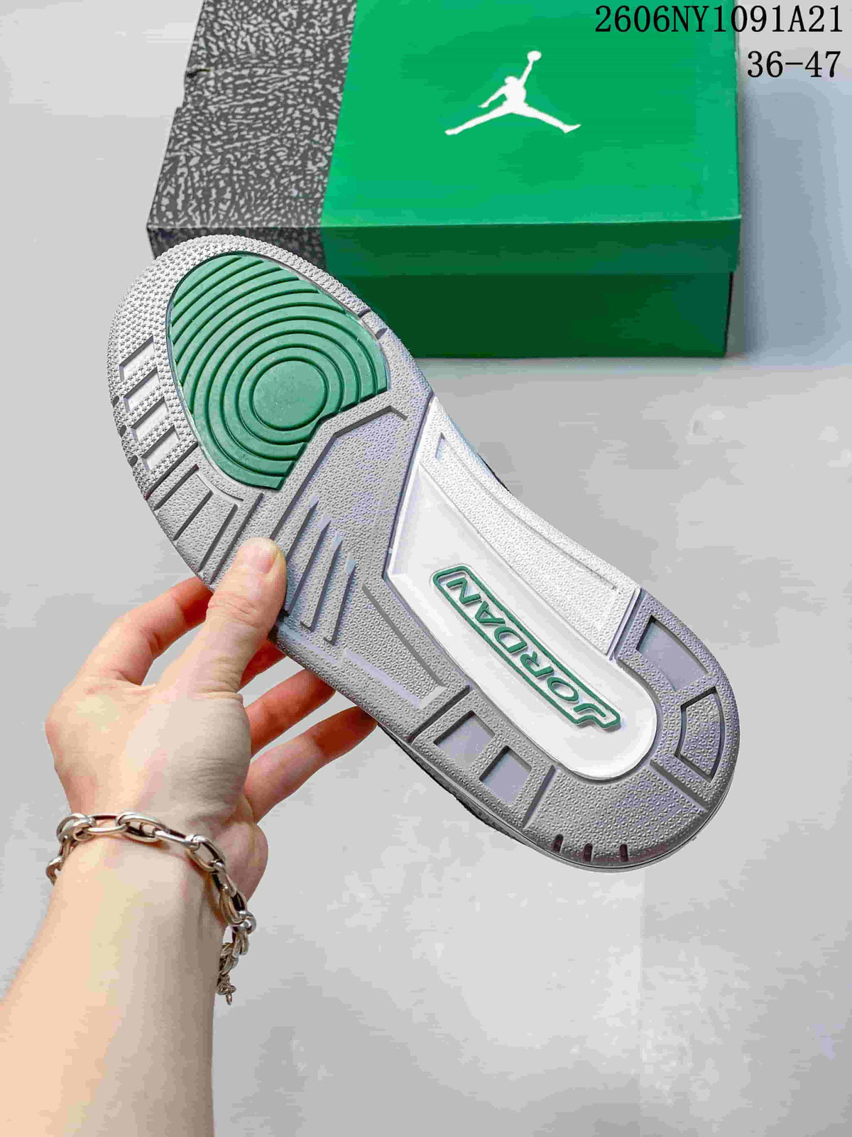 Outsole of the sneaker showing grey tread and a green circular traction area