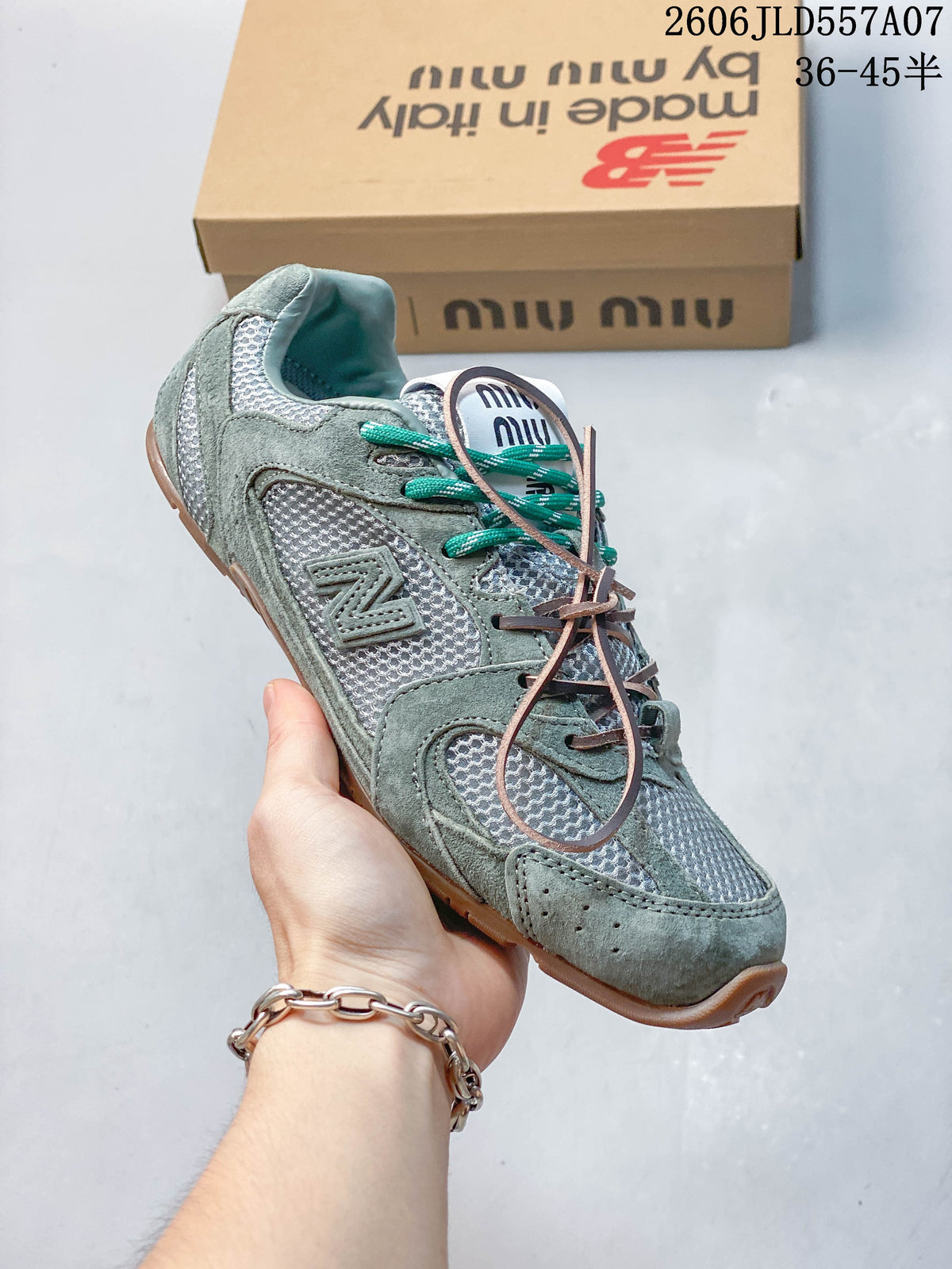 Angled side view of the sage-green and silver sneaker with a layered upper and gum-tone outsole