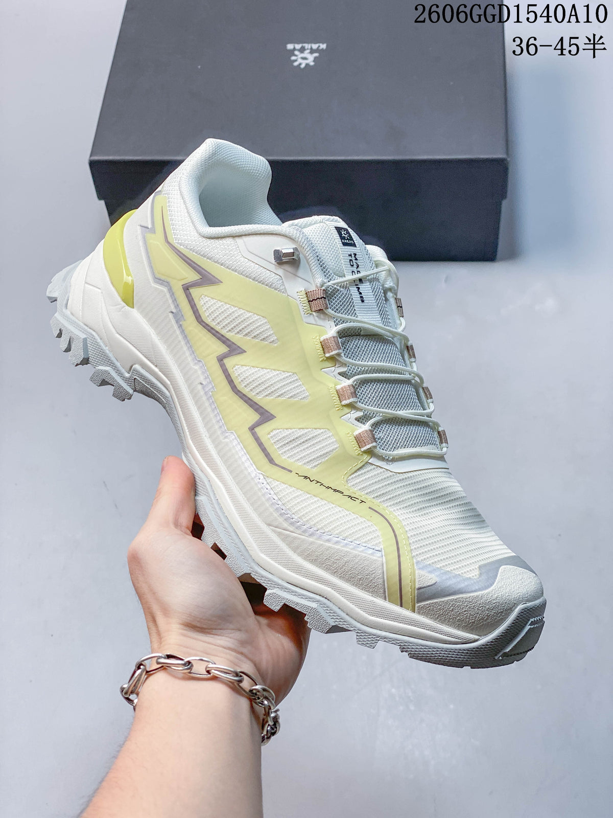 Side view of a white KAILAS hiking shoe with pale lime accents and a rugged outsole.